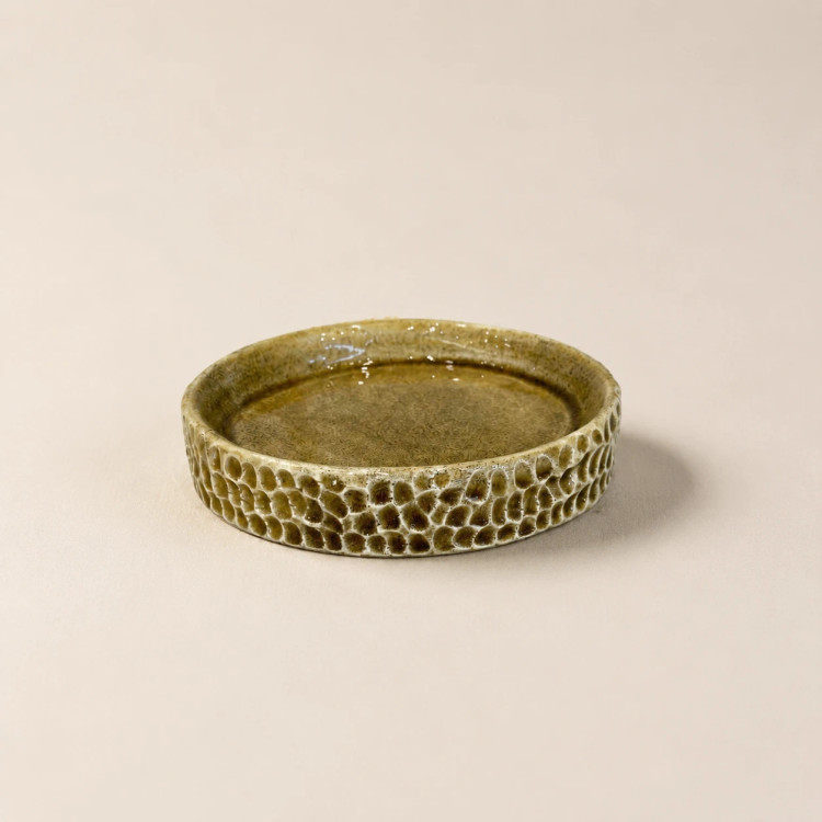 Handcrafted round ceramic dish with olive green glaze and carved honeycomb texture